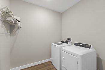 A small laundry room with a washer and dryer.
